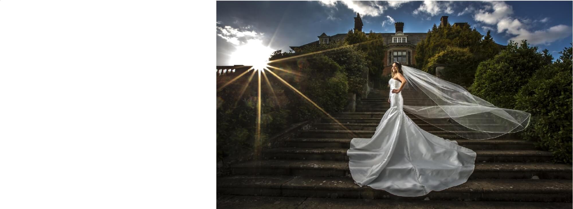 Wedding Photography Warwickshire: Bride with evening sun and veil blowing out in the wind at Dunchurch Park