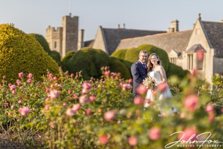 Bride and groom in the rose garden at Rockingham Castle