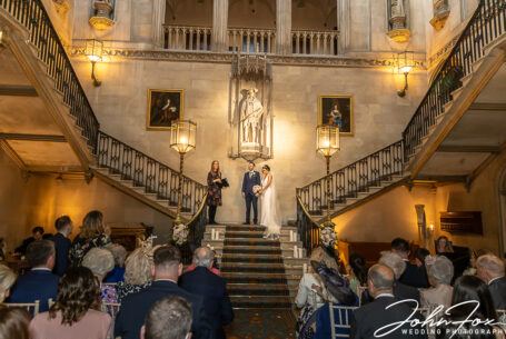 Nicole and Nicholas' Wedding Ceremony on the stairs at Ashridge House. Wedding Photography Packages in Hertfordshire by John Fox