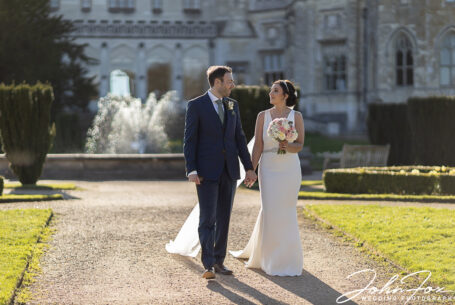 Nicole and Nicholas walking in the grounds at Ashridge House. Hertfordshire wedding packages by John Fox.
