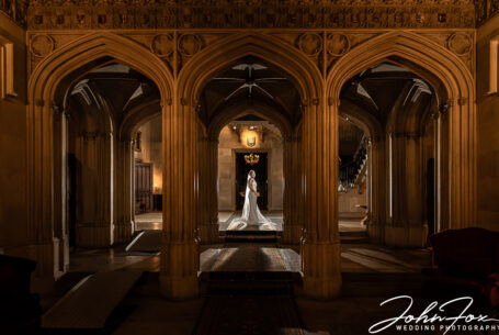 Stunning image of the bride and groom framed by arches at Ashridge House, Hertfordshire