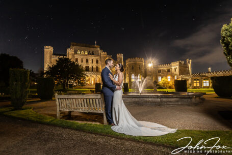 Bride and Groom, Nicole and Nicholas, at night outside Ashridge House with stars in the sky.