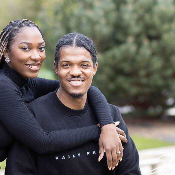 Osly with her arms around Yemi at their pre-wedding photo shoot created by John Fox Wedding Photography