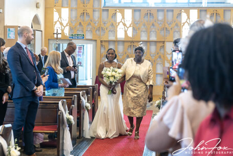Mother giving Bride away walking down the aisle at a church in Kings Heath, Birmingham