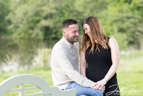 Hollie and Darren sitting near a lake in the grounds at Fawsley Hall, Northamptonshire.