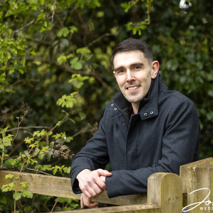 Andy, the groom-to-be, standing at a field gate in Loughborough
