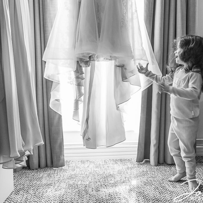 A girl in awe of the wedding dress at The Barns at Hunsbury Hill, Northamptonshire