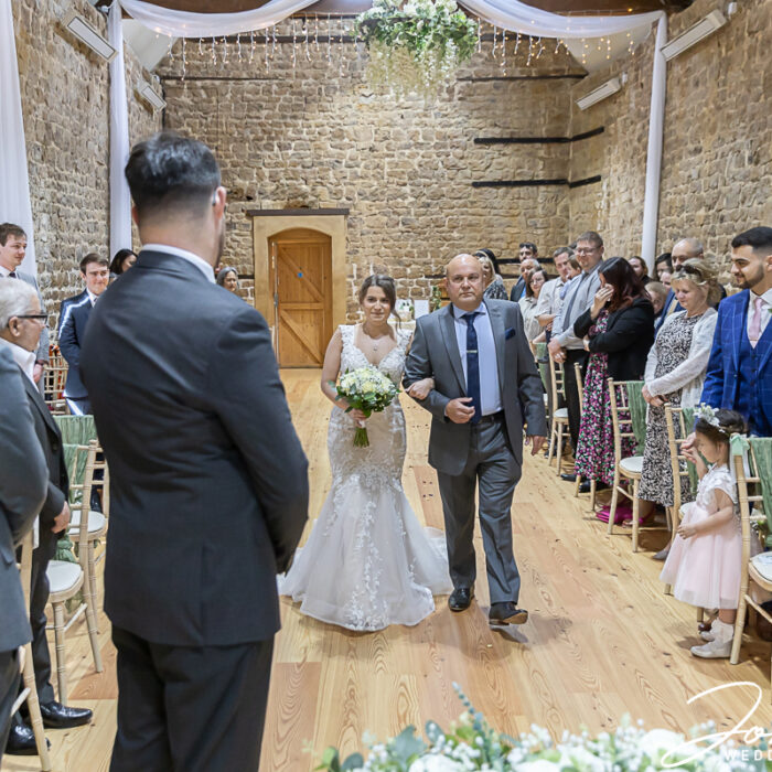 The wedding ceremony begins at The Barns at Hunsbury Hill, Northamptonshire
