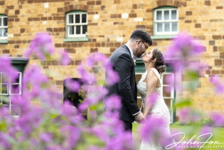A tender moment for the bride and groom in the gardens at The Barns at Hunsbury Hill