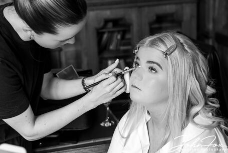 Zoe the bride getting ready at Ashridge House. Black and white photo by John Fox.
