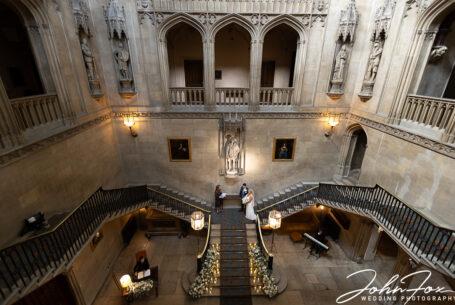 Image looking down on the bride and groom wedding ceremony on the grand staircase at Ashridge House