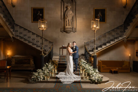 Bride and groom on the grand staircase at Ashridge House, Hertfordshire