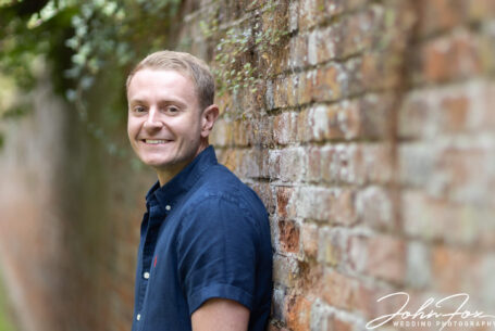 The groom to be smiling for the camera at Chicheley Hall in Buckinghamshire. Phot by John Fox Wedding Photography.