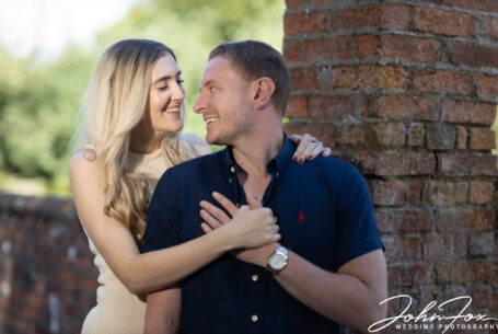 The bride and groom to be smiling at each other. John Fox Wedding Photography.