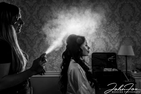 The bride having her hair styled. Photo by John Fox Wedding Photography