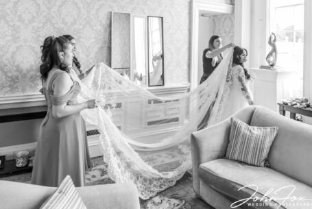 The bride preparing to leave for the ceremony with her bridesmaids at Stowe House.