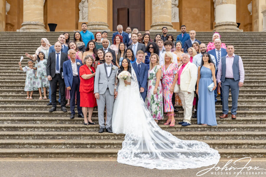 The happy couple and all their guests outside Stowe House.