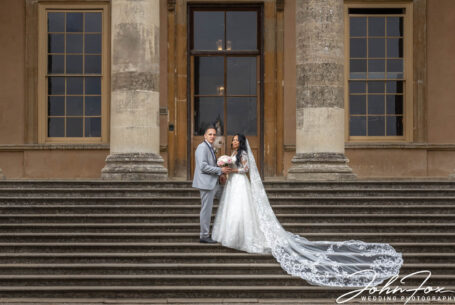The newly-wed couple on the steps at Stowe House. Photo by John Fox Wedding Photography