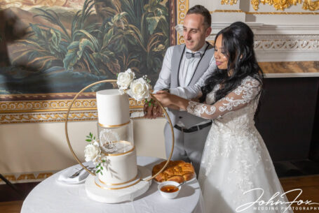 The happy couple cutting the cake at their wedding.