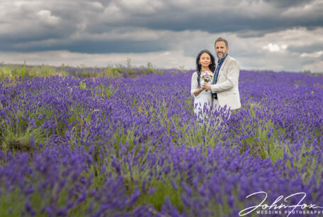The couple holding each other in the Hertfordshire lavender fields.