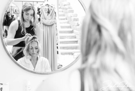 The bride having her hair styled for her wedding at Crockwell Farm. Photo by John Fox Wedding Photography.