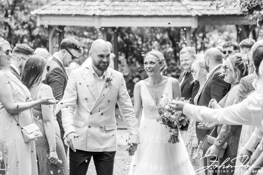 The couple being showered in confetti.