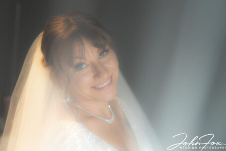 Close-up of the bride at t Meadow Barn at The Stratford Park Hotel by John Fox Wedding Photography