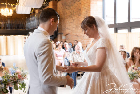 The bride and groom at their wedding ceremony at Meadow Barn, Stratford-upon-Avon.