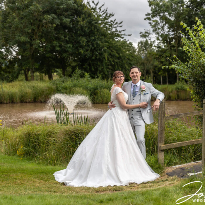 A fountain in the background enhances a perfect moment for the newly wedded couple. Image by John Fox Wedding Photography