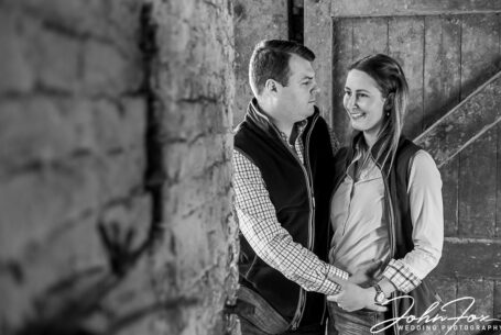 The happy couple in a barn doorway on their Derbyshire farm
