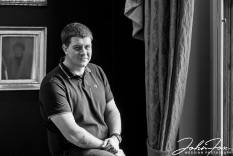 Black and white image of Joshua, the groom, on his pre-wedding shoot at Ashridge House with John Fox Wedding Photography.