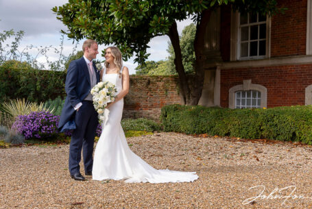 Lorna and James have a quiet moment in the grounds at Chicheley Hall on their wedding day