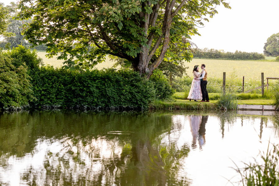 Northampton and Northamptonshire Wedding Photographer. Bride and groom reflection in the lake at Furtho Manor Farm