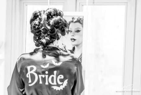 The bride in the mirror with her gothic dressing gown with bats on the back