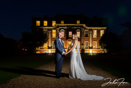 Bride and groom at night in front of Chicheley Hall