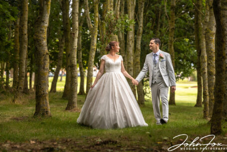 Wedding Photographer Coventry and Warwickshire. Bride and groom walking in woodland
