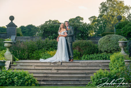 Bride and Groom in the gardens and grounds at Tissington Hall by John Fox.