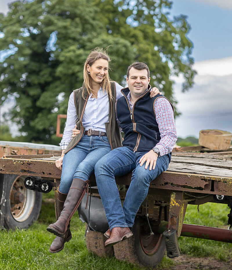 Bride and Groom to be sat on the farm trailer together