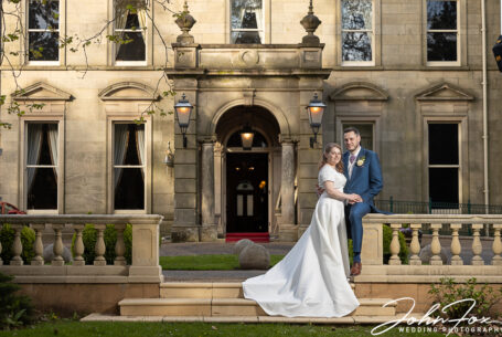 Bride and Groom in front of Kilworth House entrance. Photo by John Fox Wedding Photography.