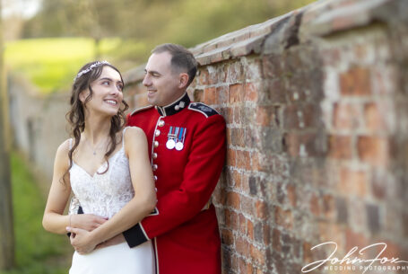 Bride and groom's wedding photograph at Eversholt Hall with groom in military uniform