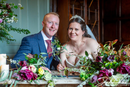 Bride and Groom signing the register at Pauntley Court