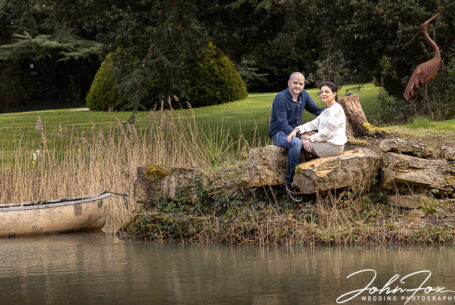 Cheltenham’s Manor by the Lake. An image of the couple by the lake. Taken by John Fox Wedding Photography.