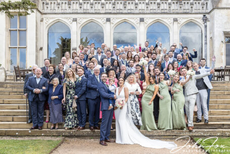 All the wedding guests group image on the steps at Ashridge House