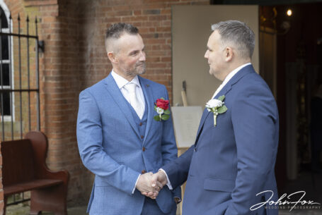 Best man wishing the groom best of luck before the wedding at Coombe Abbey, Coventry.