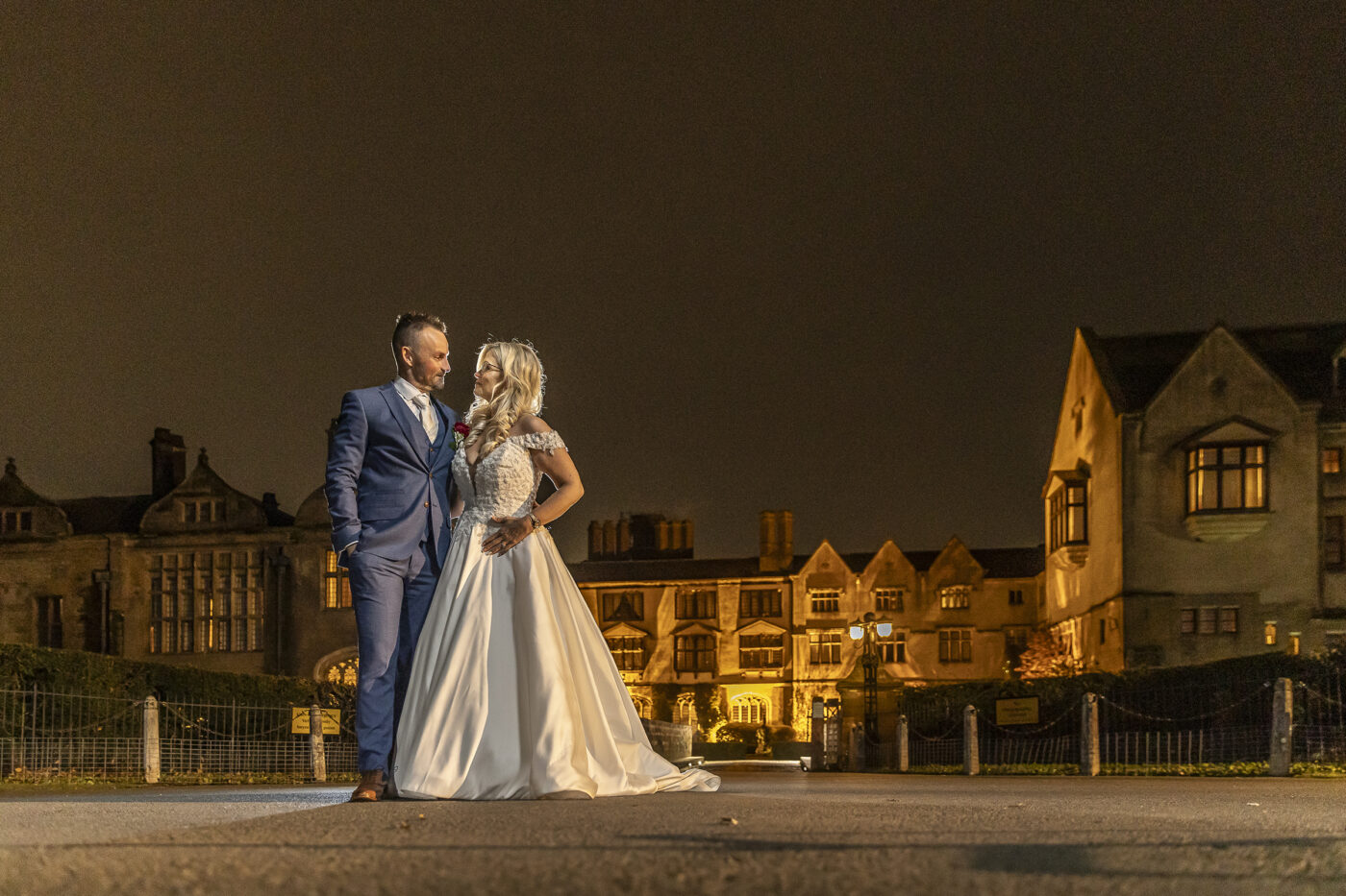 Bride and Groom in front of Coombe Abbey at night by John Fox