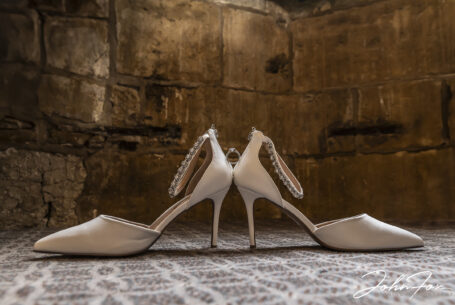 Valentine’s Weekend Wedding Photography at Fawsley Hall. Image of the Bride's shoes and engagement ring