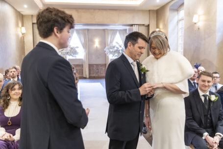 Exchange of wedding rings during the ceremony at Fawsley hall. Photo by John Fox Wedding Photography.