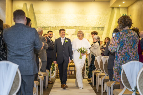 Bride and groom walking down the aisle at Fawsley Hall