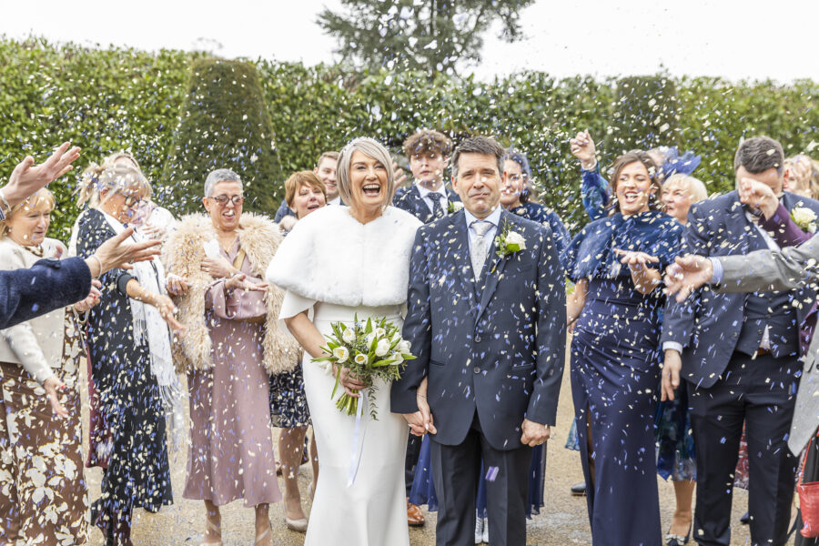 Confetti image with interesting expressions on bride and groom by John Fox Wedding Photography.