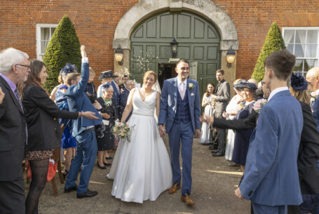People throwing confetti at a wedding